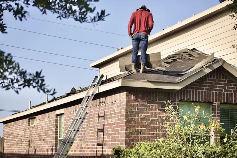 Professional roofer working on a residential roof in Sauratown Estates